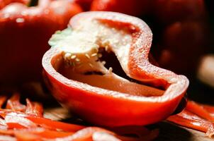 Chopped sweet pepper. On black table. photo