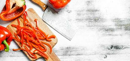 Chopped sweet pepper. On white table. photo