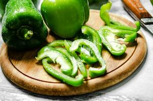 Chopped sweet pepper. On white table. photo