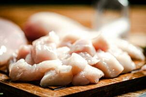 Sliced chicken fillet. On cutting board. photo