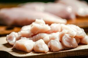 Sliced chicken fillet. On cutting board. photo