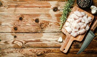 Sliced chicken fillet. On cutting board. photo