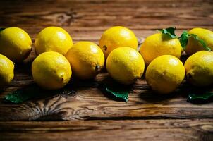 Fresh lemons. On wooden table. photo