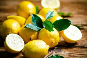 Fresh lemons. On wooden table. photo