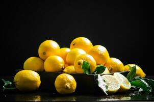 Fresh lemons. On black table. photo