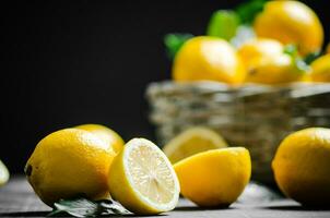 Fresh lemons. On black table. photo