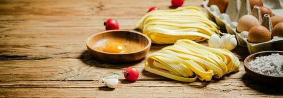 Homemade pasta tagliatelle. On wooden table. photo