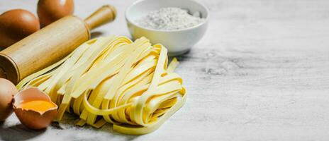 Homemade pasta tagliatelle. On white table. photo