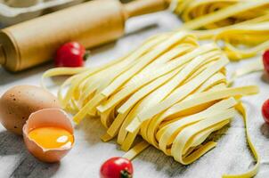 Homemade pasta tagliatelle. On white table. photo