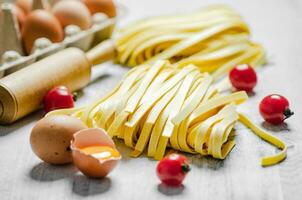 Homemade pasta tagliatelle. On white table. photo