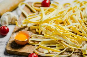 Homemade pasta tagliatelle. On white table. photo