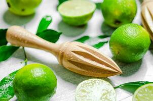 Fresh limes. On white table. photo