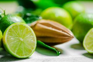 Fresh limes. On white table. photo