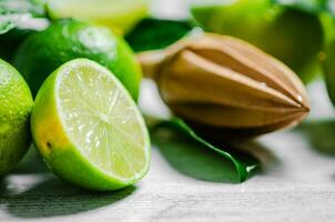 Fresh limes. On white table. photo