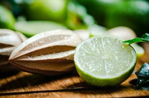 Fresh limes. On wooden table. photo