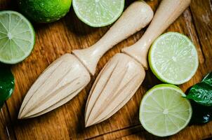 Fresh limes. On wooden table. photo