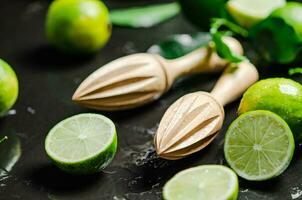 Fresh limes. On black table. photo