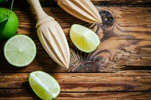 Fresh limes. On wooden table. photo
