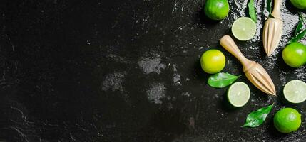 Fresh limes. On black table. photo