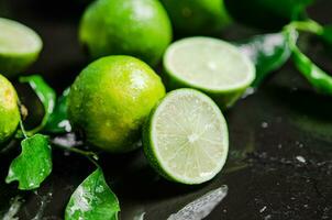 Fresh limes. On black table. photo