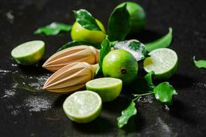 Fresh limes. On black table. photo