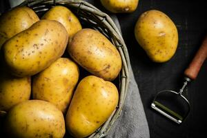 Fresh potatoes. On black background. photo