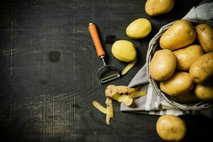 Fresh potatoes. On black background. photo