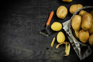 Fresh potatoes. On black background. photo