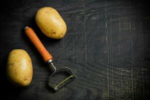 Fresh potatoes. On black background. photo