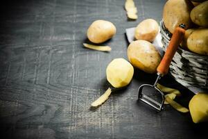 Fresh potatoes. On black background. photo