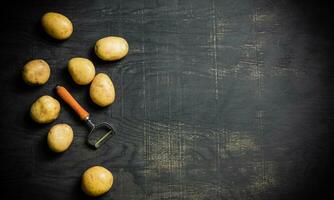 Fresh potatoes. On black background. photo