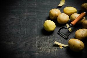 Fresh potatoes. On black background. photo