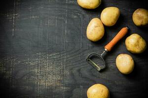 Fresh potatoes. On black background. photo