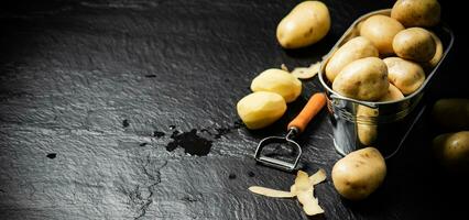 Fresh potatoes. On black background. photo