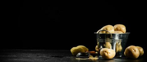 Fresh potatoes. On black background. photo