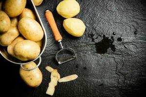 Fresh potatoes. On black background. photo