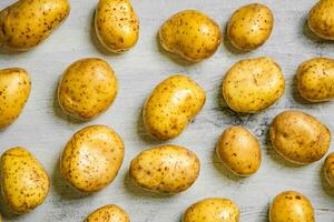 Fresh potatoes. On white table. photo