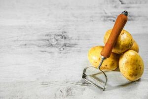 Fresh potatoes. On white table. photo