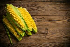 Fresh corn on wooden table. photo