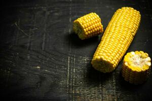 Corn on dark table. photo