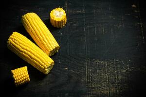 Corn on dark table. photo