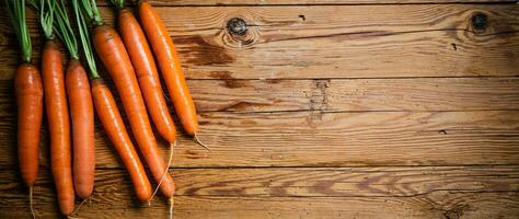 Fresh carrots on wooden table. photo