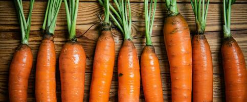 Fresh carrots on wooden table. photo