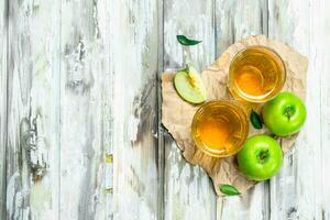 Apple juice in a glass Cup on a wooden Board. photo