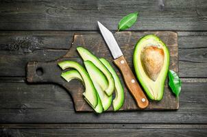 Pieces of avocado on a chopping Board. photo