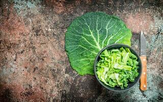 Cabbage salad in a bowl with a knife. photo