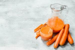 Carrot juice in the pitcher. photo