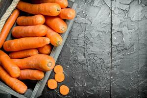 Ripe carrot in a wooden box. photo