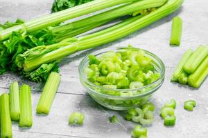 Pieces of celery in a glass bowl. photo