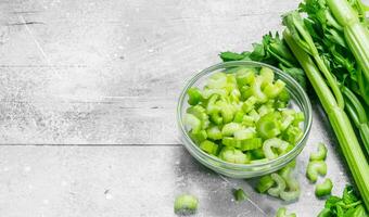 Pieces of celery in a glass bowl. photo